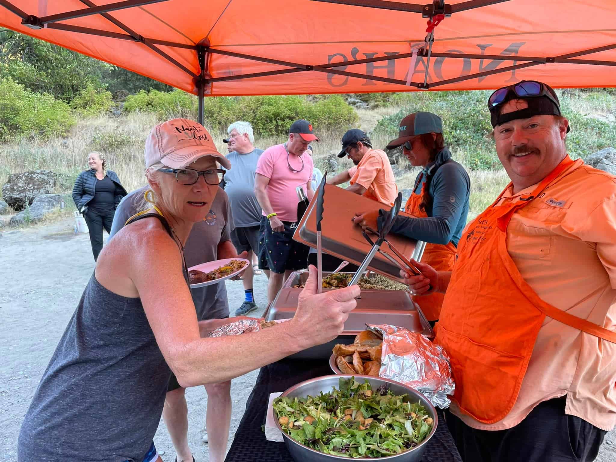 Guests enjoying a freshly prepared riverside buffet