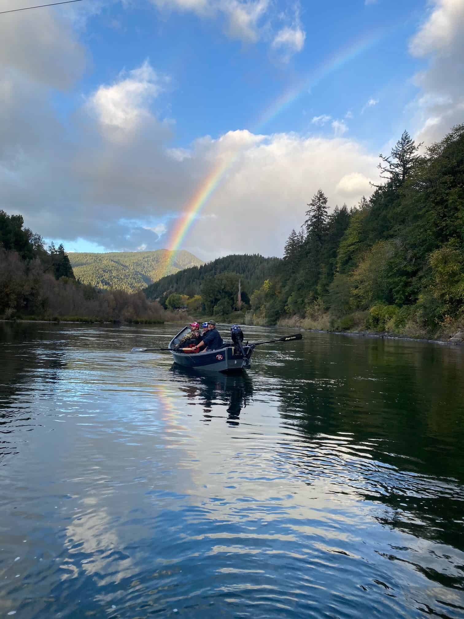 A colorful Rogue River fish held above the water